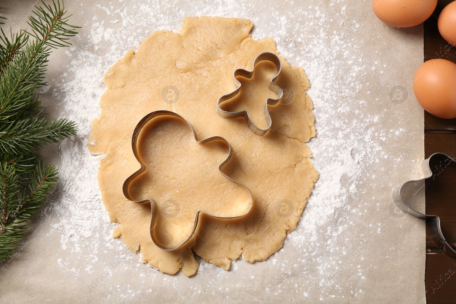 Photo of Making Christmas cookies. Raw dough and cutters on table, flat lay