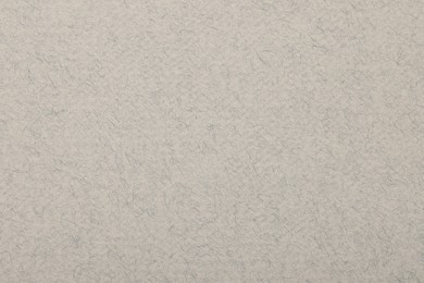 Photo of Texture of light grey paper sheet as background, top view