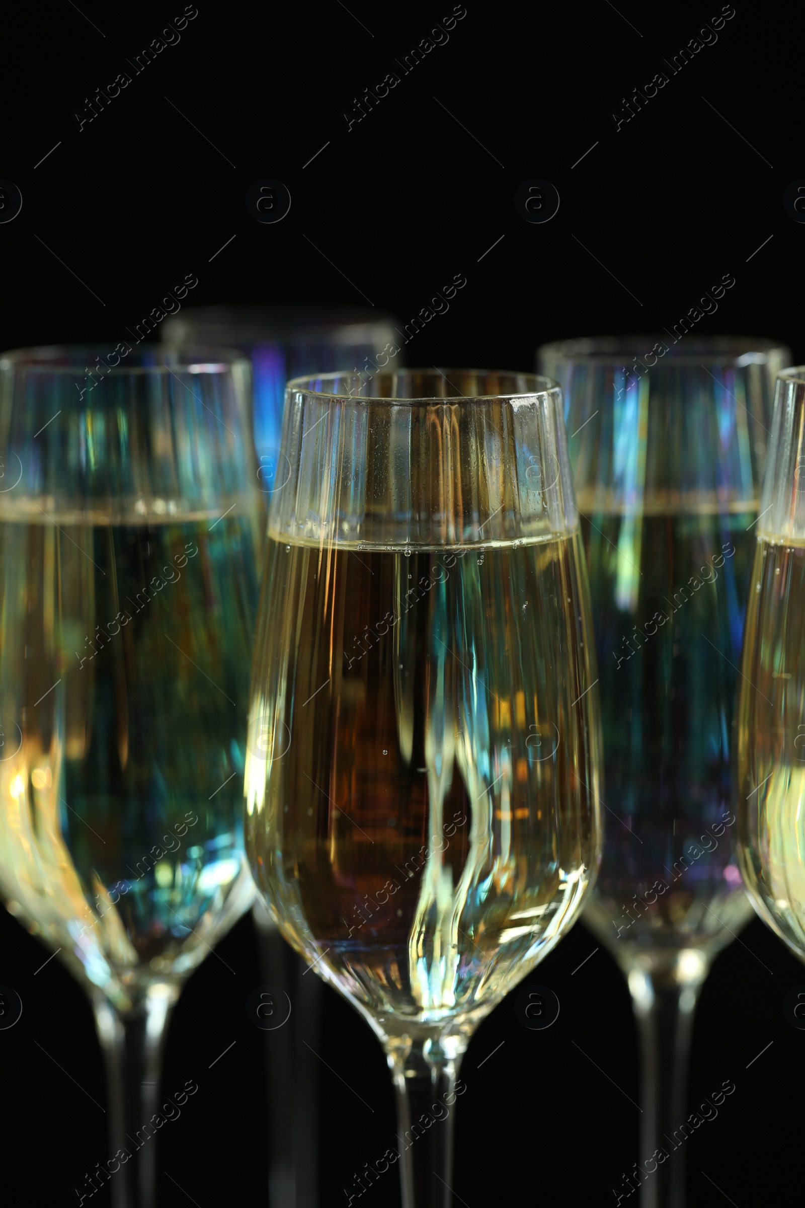 Photo of Glasses of champagne on black background, closeup