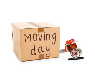 Moving box, marker and adhesive tape dispenser on white background