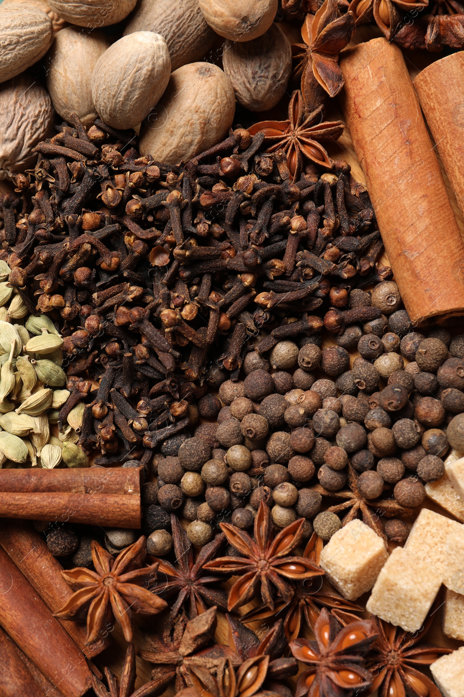 Photo of Different spices and nuts as background, top view