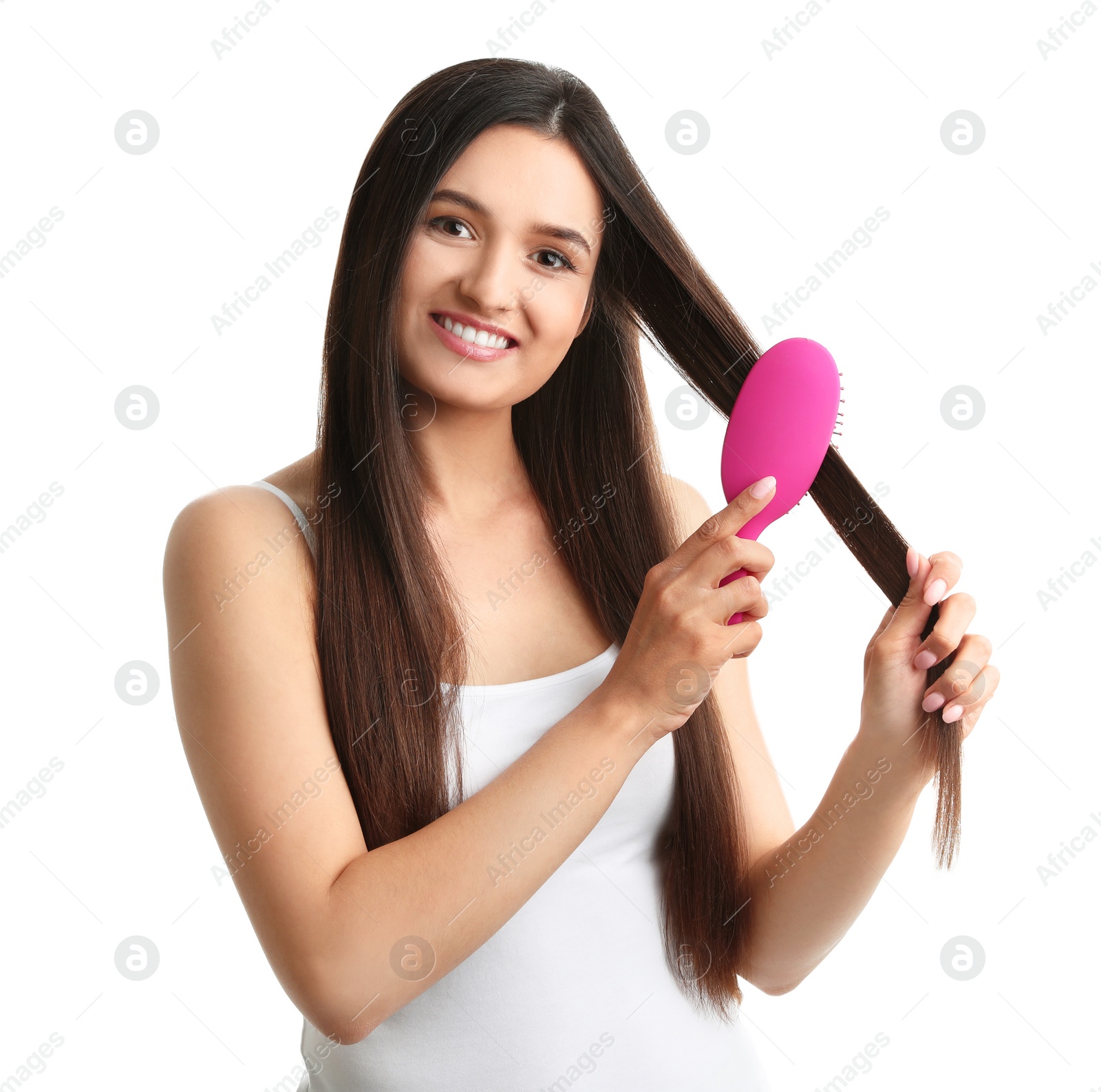 Photo of Beautiful young woman with hair brush on white background