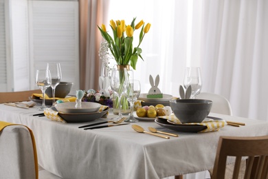 Photo of Beautiful Easter table setting with festive decor indoors