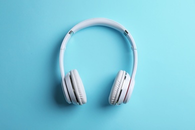 Photo of Wireless headphones on color background, top view