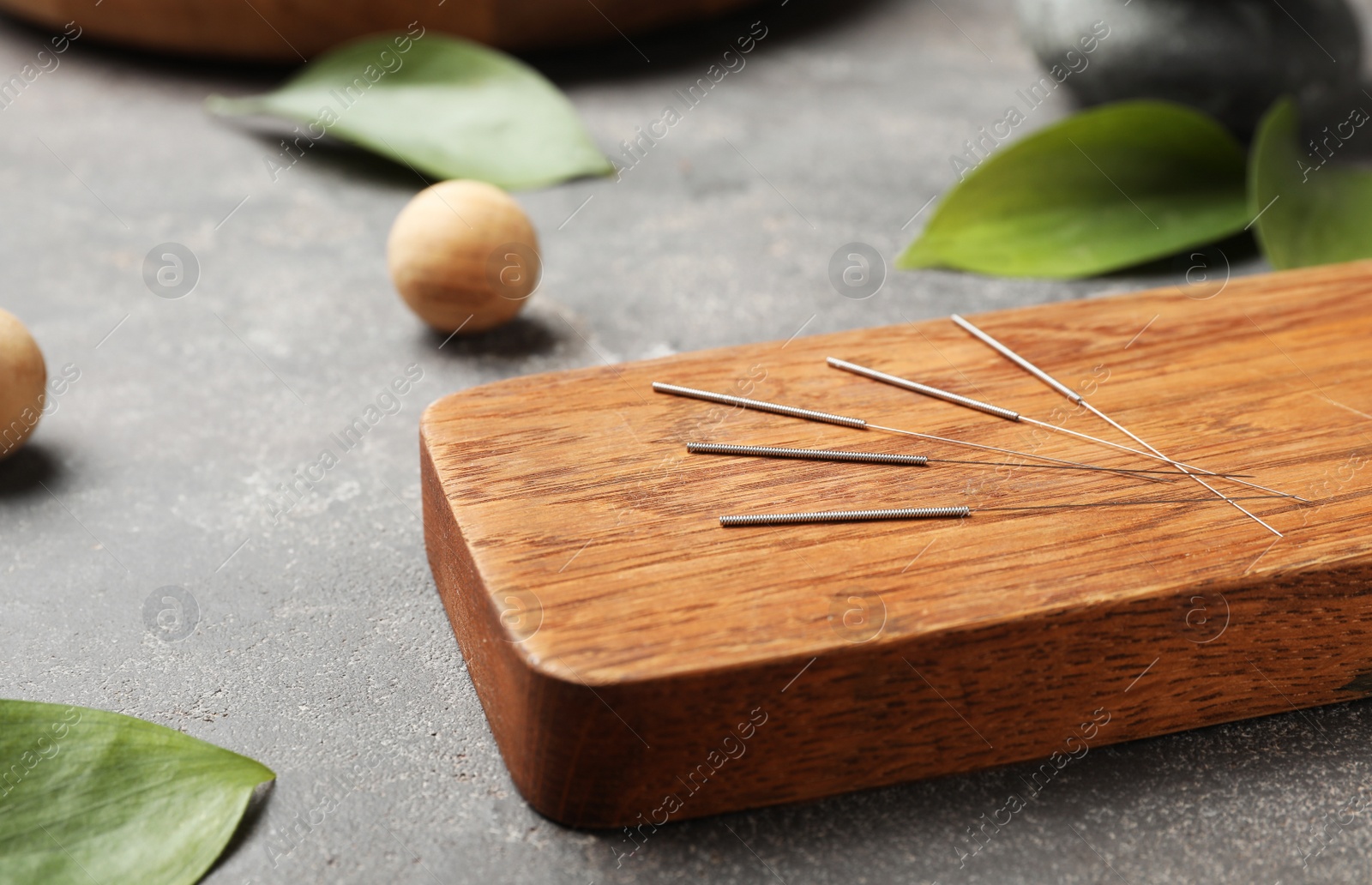 Photo of Board with needles for acupuncture on dark table