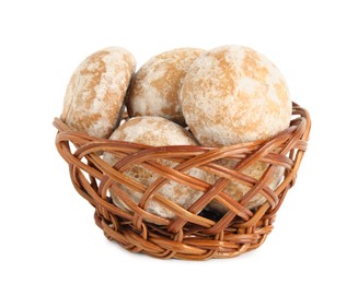 Tasty homemade gingerbread cookies in wicker basket on white background