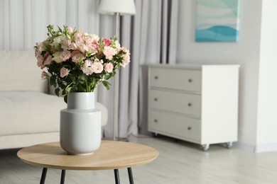 Photo of Beautiful bouquet of fresh flowers in vase on wooden coffee table indoors, space for text