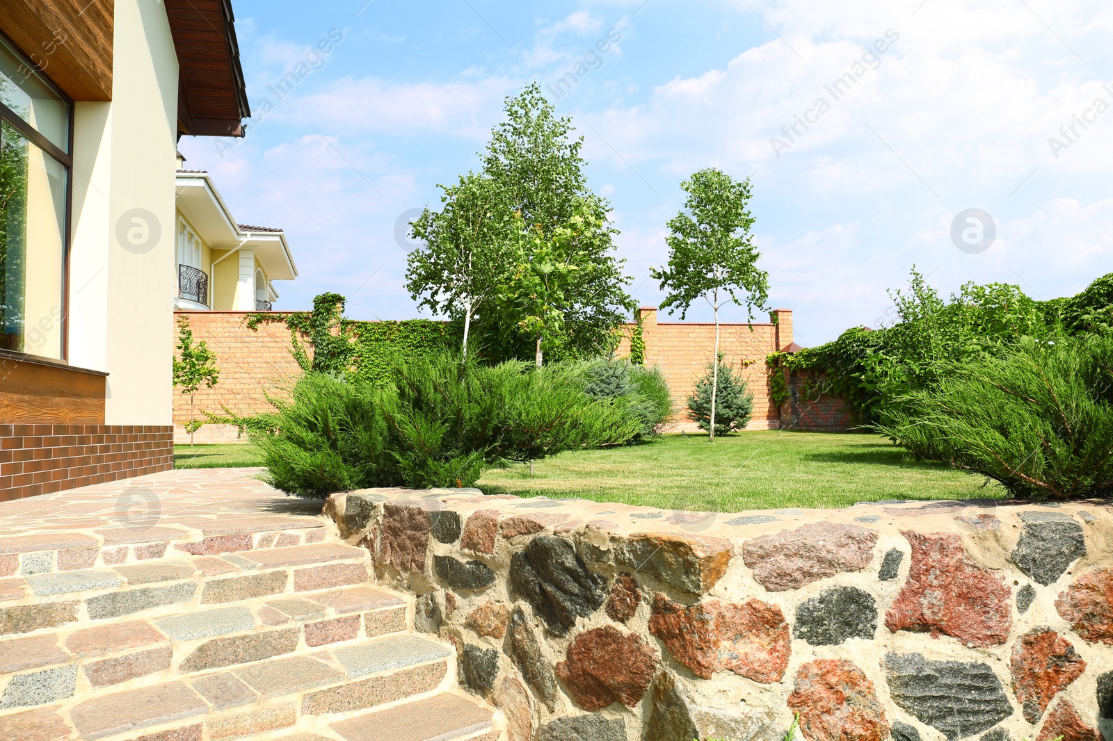 Photo of Landscape with modern house and beautiful garden on sunny day