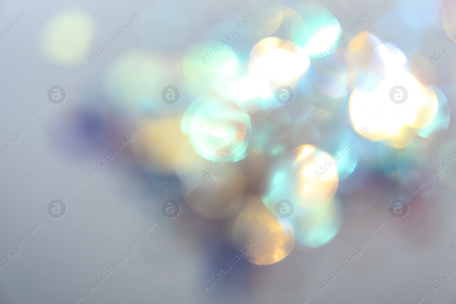 Photo of Blurred view of shiny lights on light background. Bokeh effect