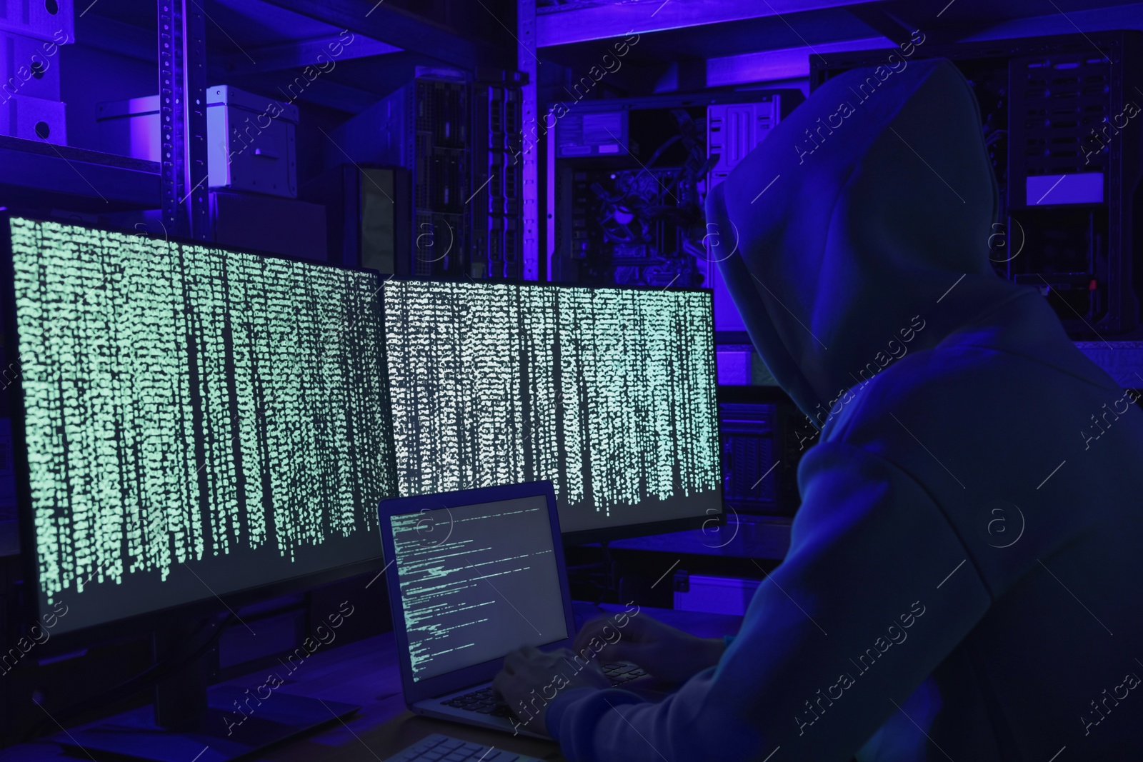 Photo of Hacker working with computers in dark room. Cyber attack