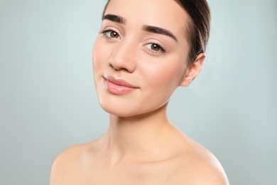 Photo of Portrait of young woman with beautiful face against color background