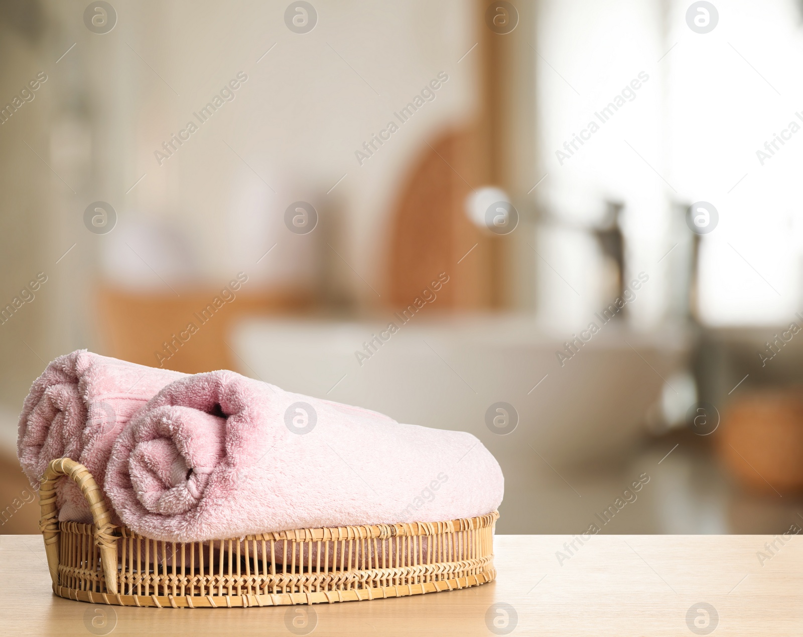 Image of Fresh towels on wooden table in bathroom. Space for text