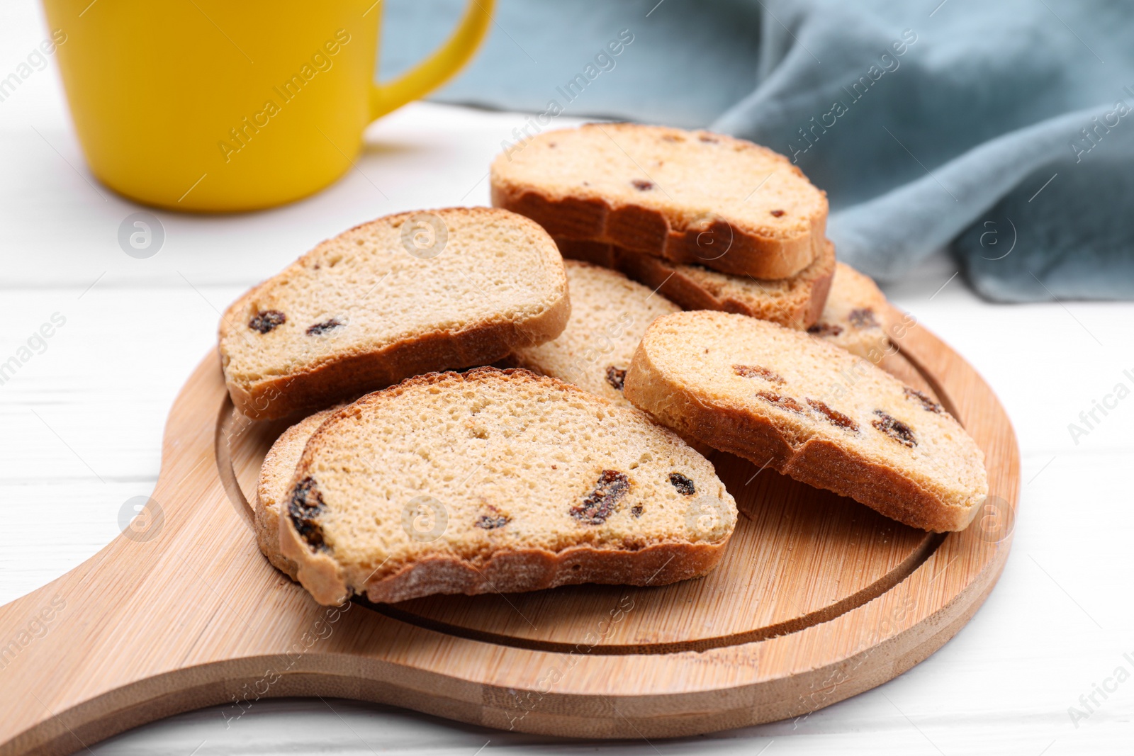 Photo of Sweet hard chuck crackers with raisins on white wooden table