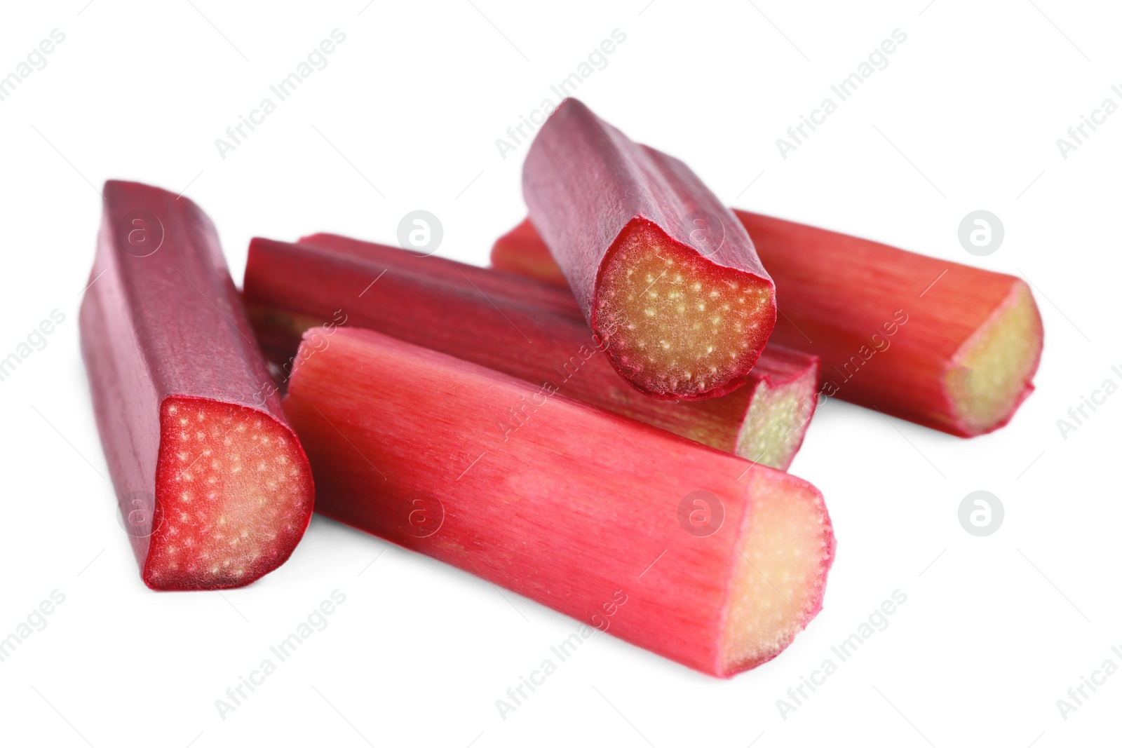 Photo of Stalks of fresh ripe rhubarb isolated on white