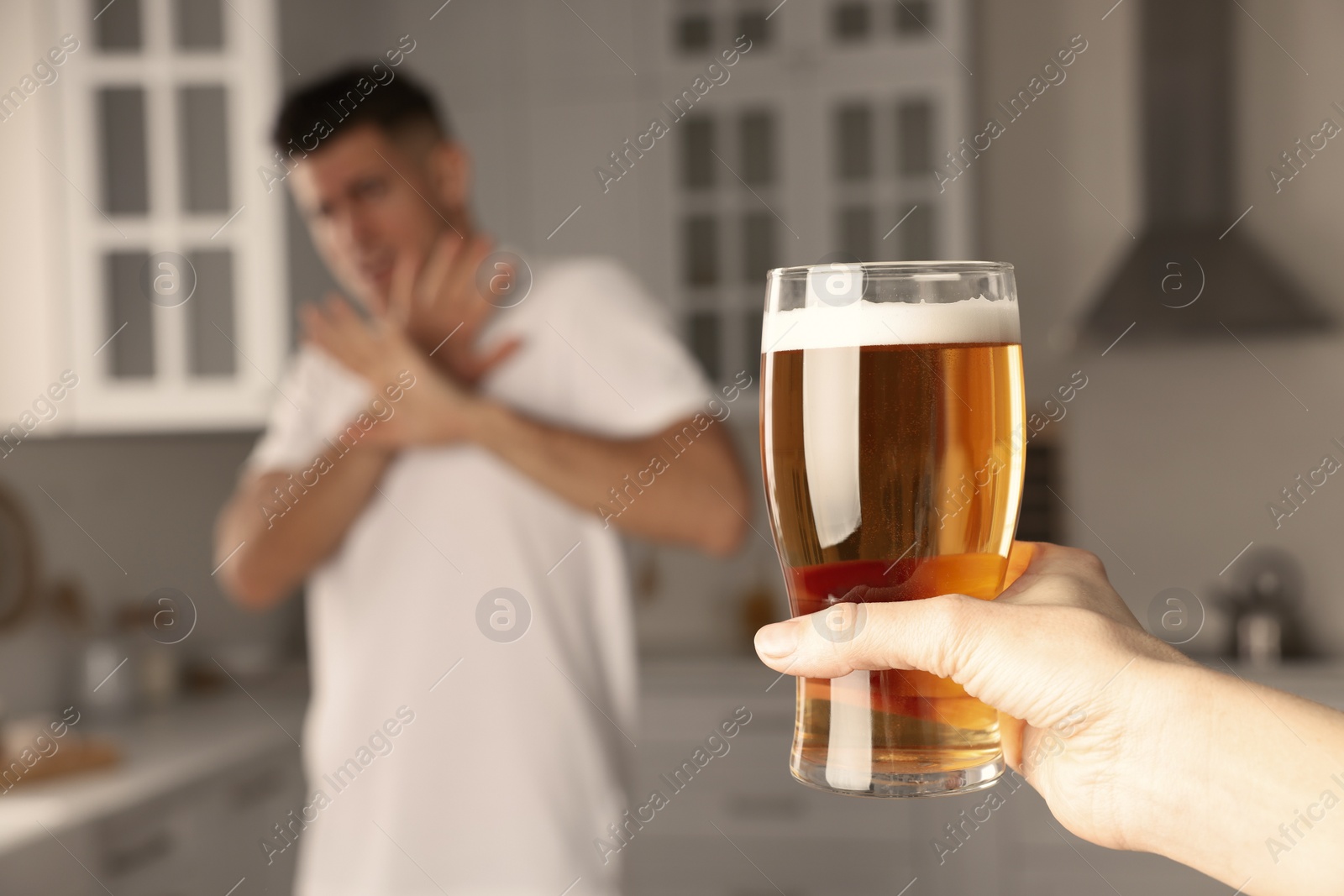 Photo of Man refusing to drink beer in kitchen, closeup. Alcohol addiction treatment