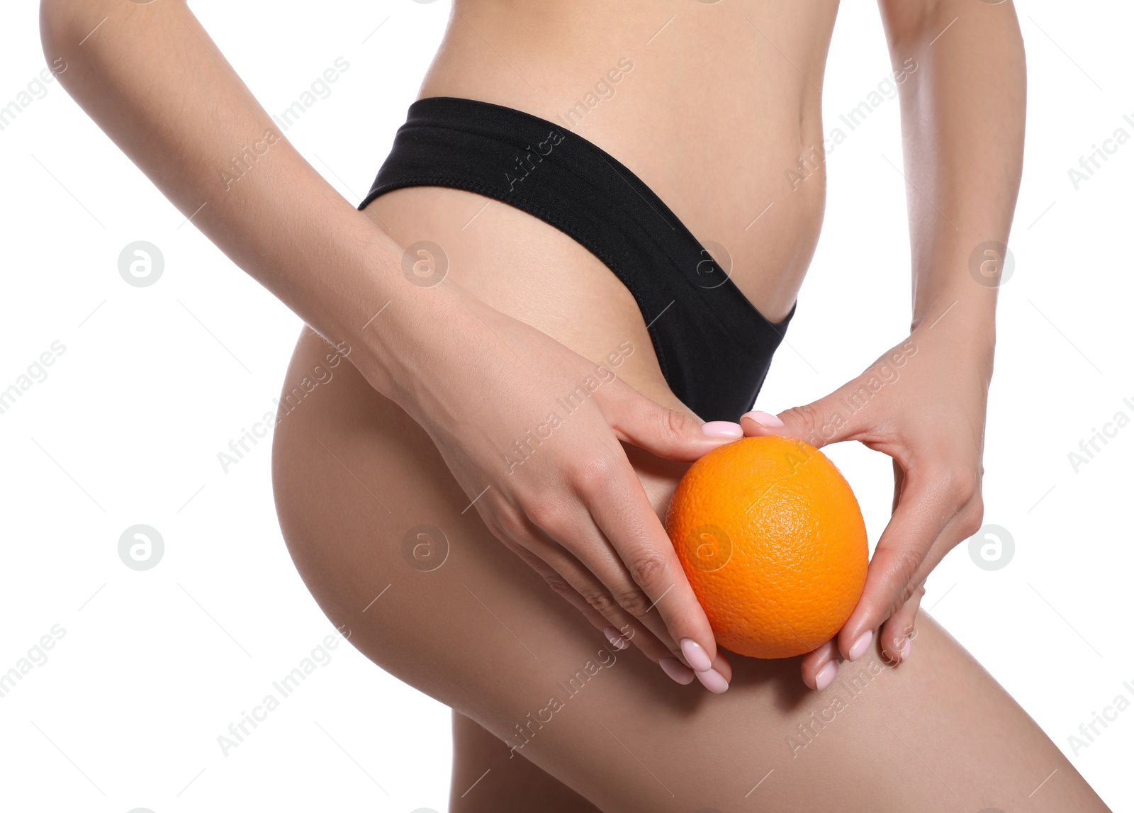 Photo of Closeup view of slim woman in underwear with orange on white background. Cellulite problem concept