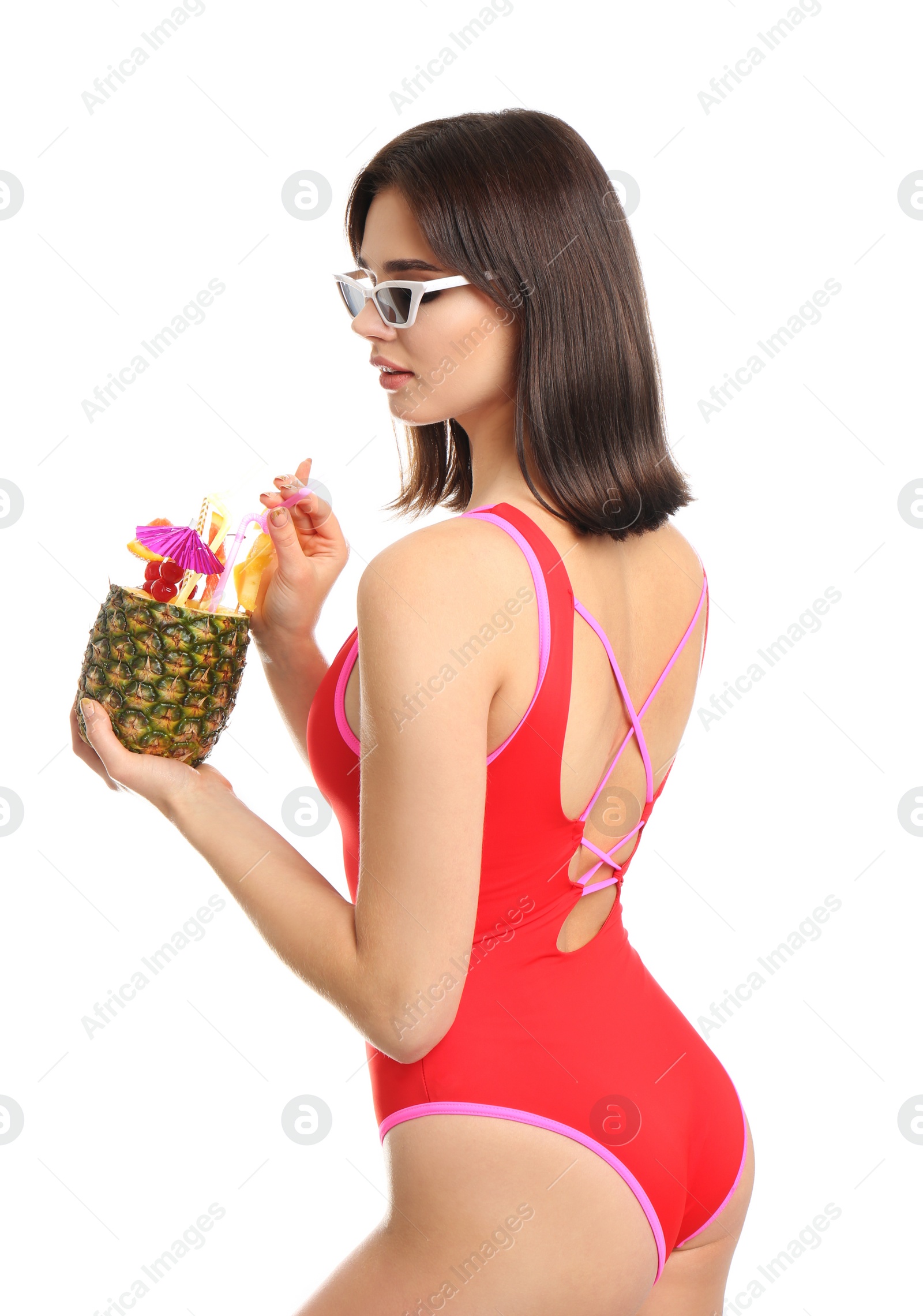 Photo of Beautiful young woman with exotic cocktail wearing swimsuit and sunglasses on white background