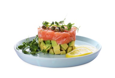 Tasty salmon tartare with avocado, lemon, capers and microgreens isolated on white