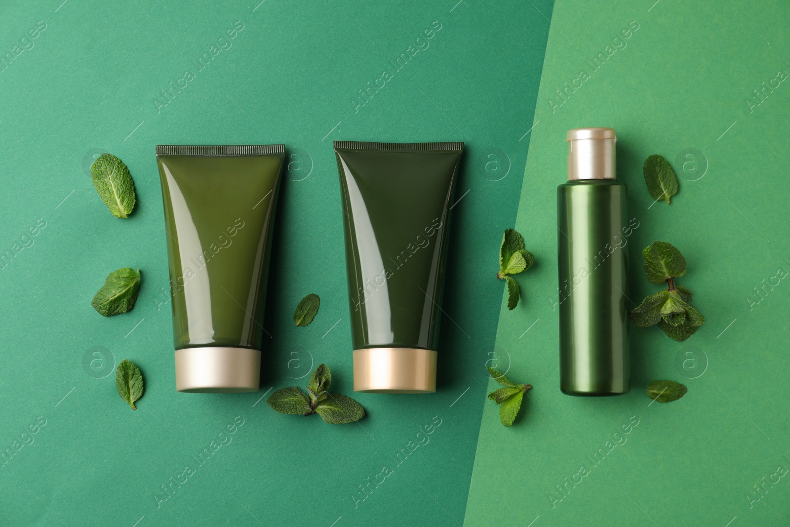 Photo of Flat lay composition with cosmetic products on green background