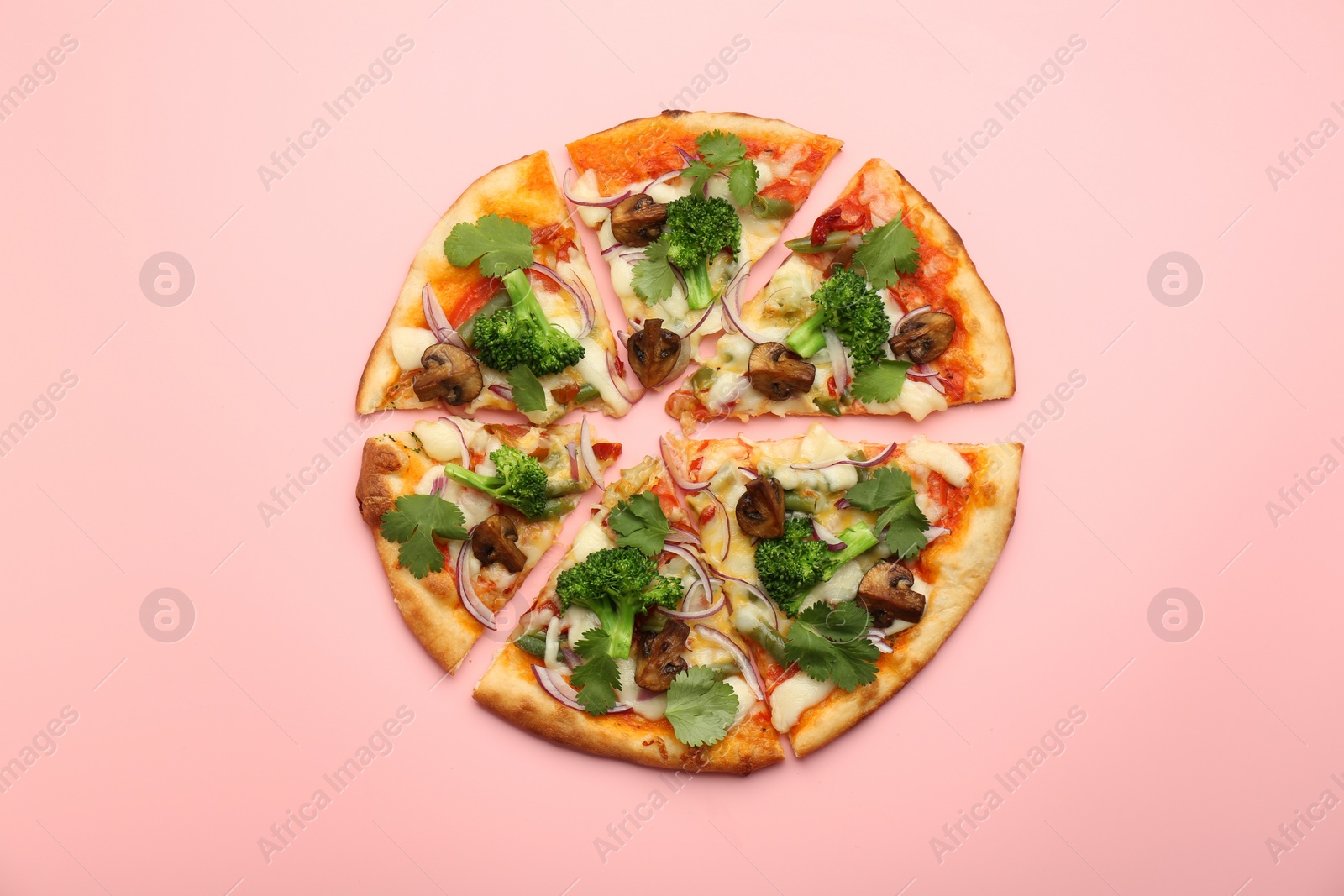 Photo of Delicious vegetarian pizza on pink table, top view