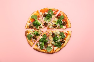 Delicious vegetarian pizza on pink table, top view