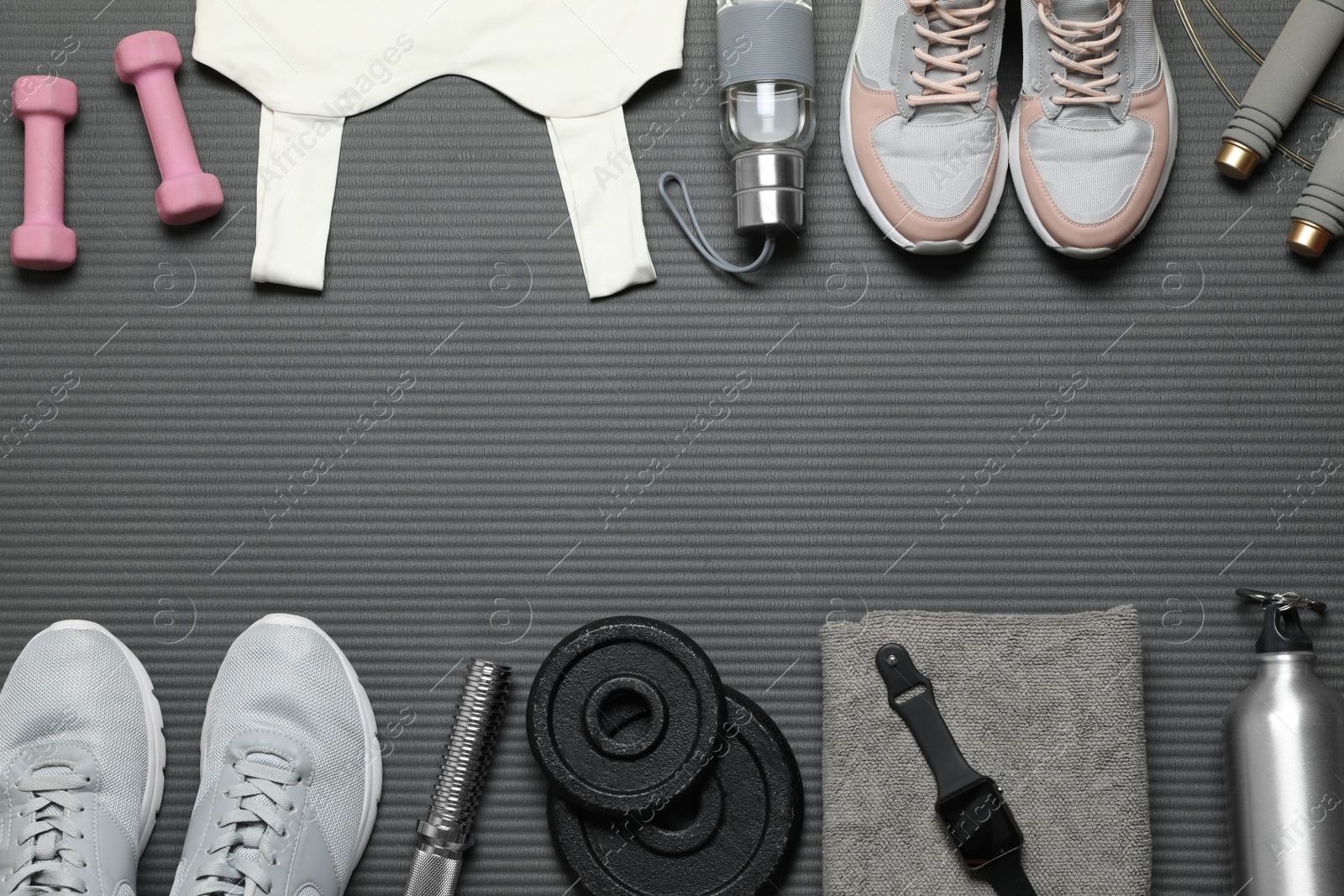 Photo of Flat lay composition with sports equipment on grey mat, space for text