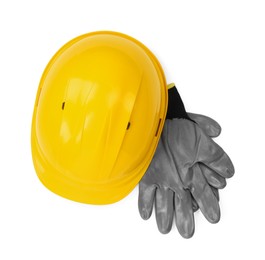 Photo of Hard hat and gloves isolated on white, top view. Safety equipment
