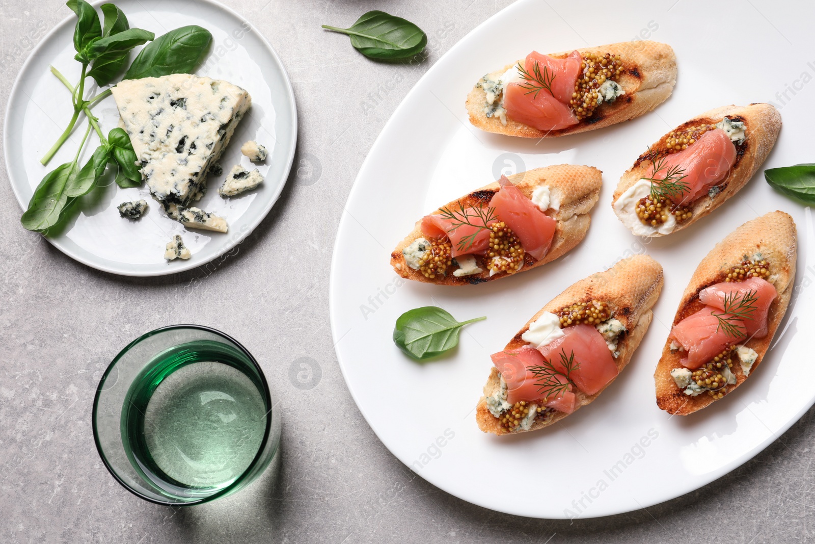 Photo of Flat lay composition with tasty bruschettas on grey table