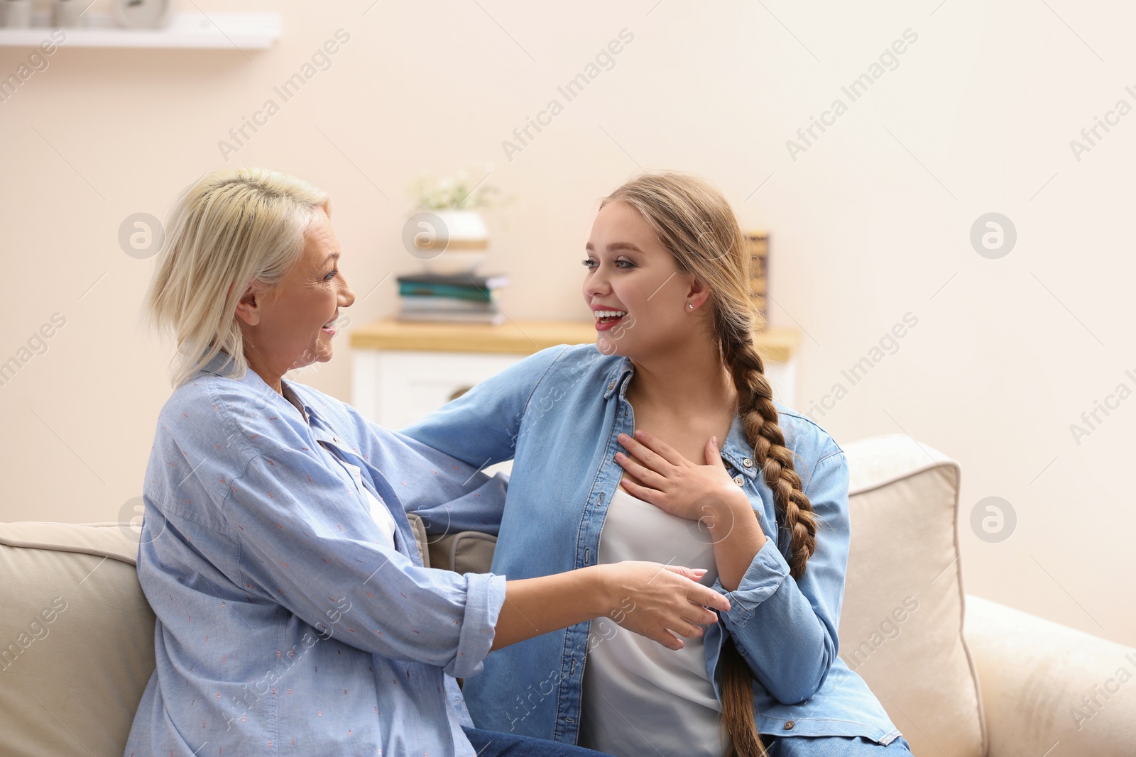 Photo of Mother and her adult daughter spending time together at home