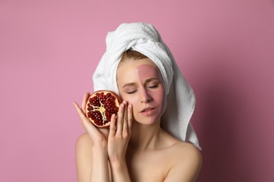 Photo of Young woman with pomegranate face mask and fresh fruit on pink background