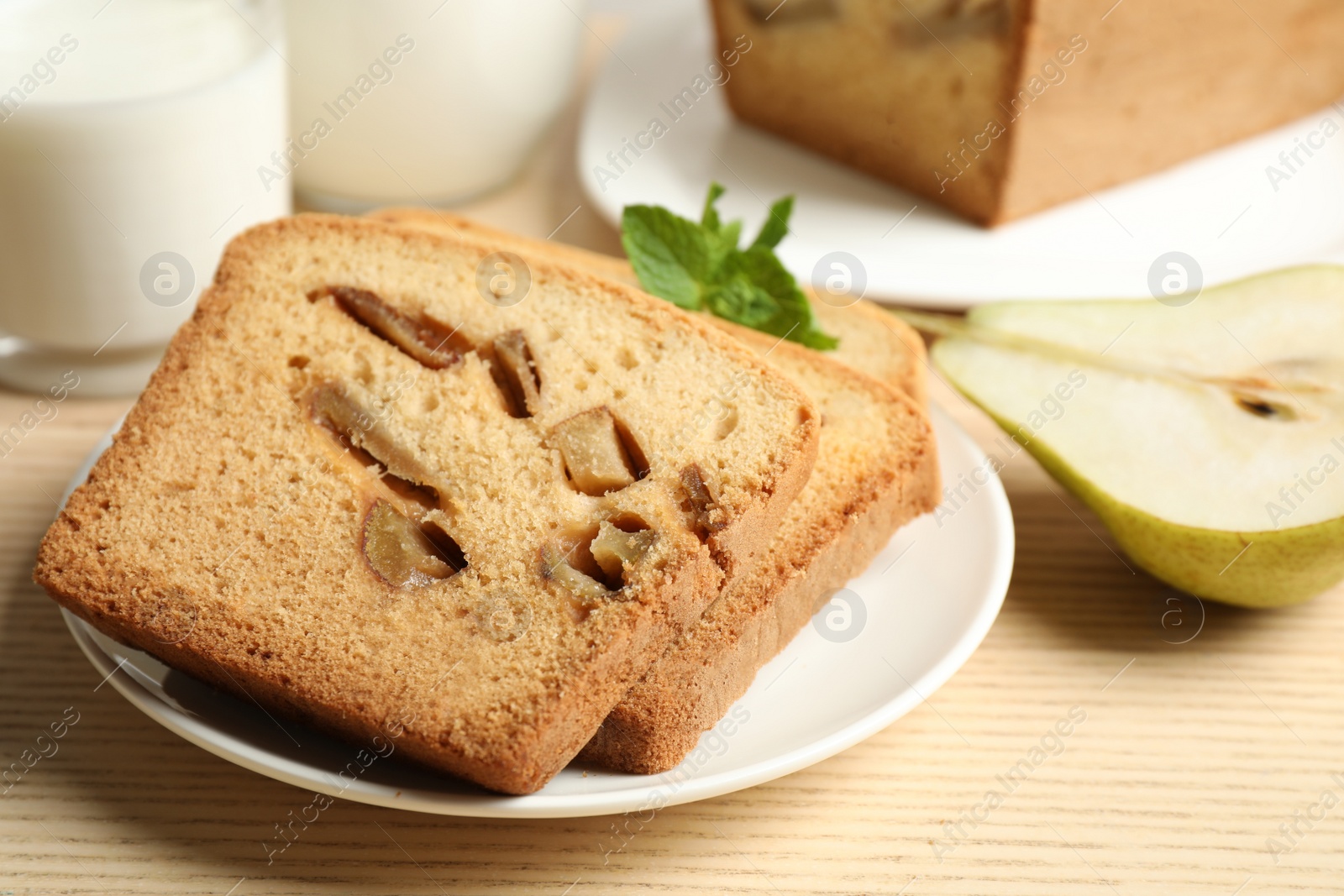 Photo of Tasty pear bread on wooden table, closeup. Homemade cake