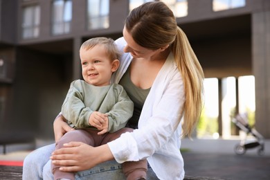 Photo of Happy nanny with cute little boy outdoors