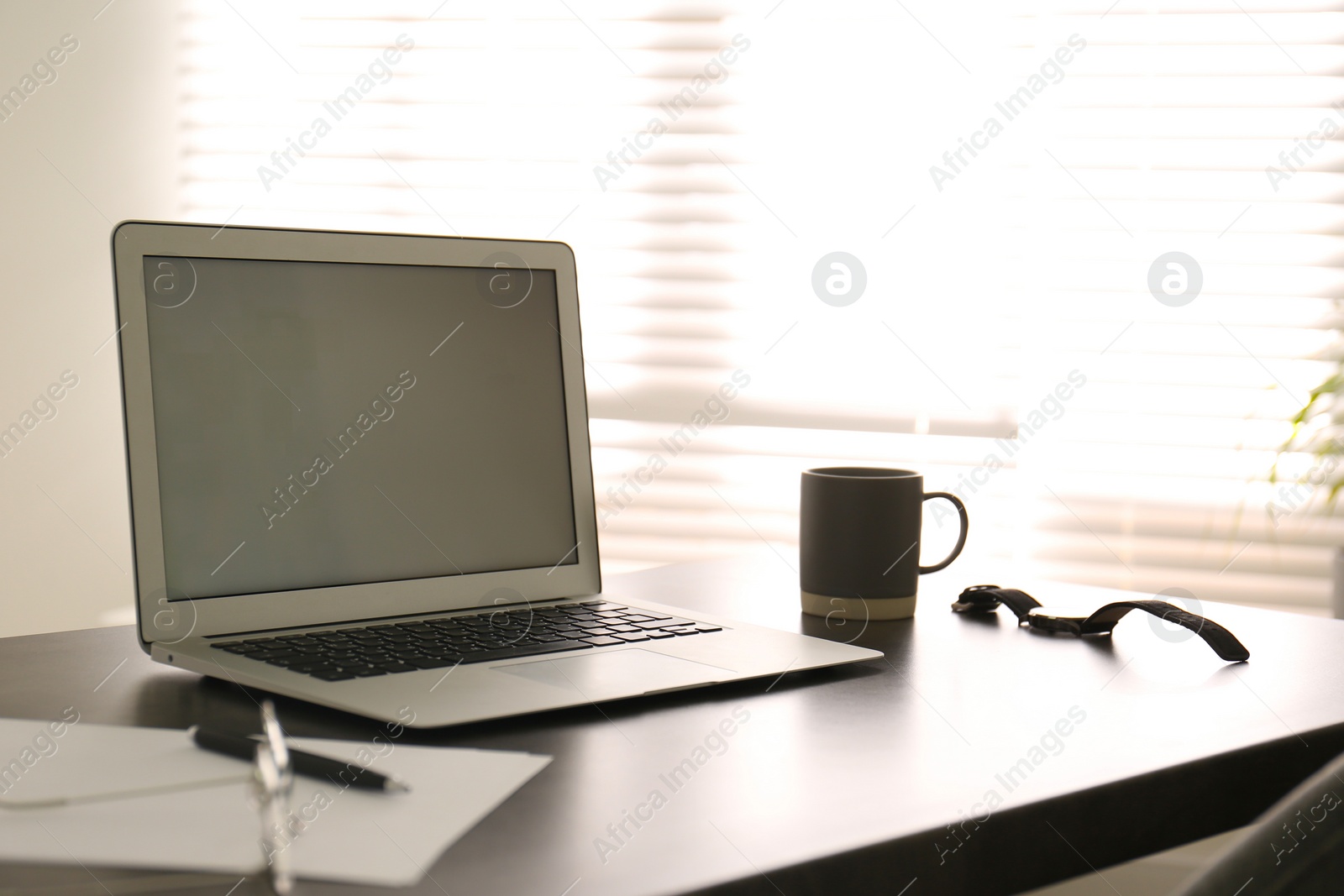 Photo of Modern laptop on office table. Stylish workplace