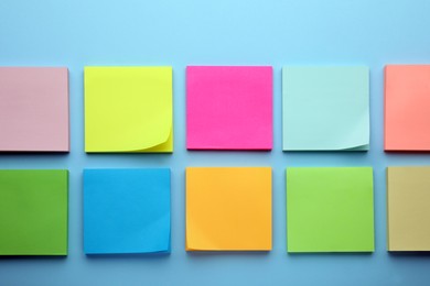 Photo of Paper notes on light blue background, flat lay