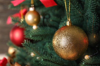 Photo of Beautiful Christmas tree with festive decor on dark background, closeup