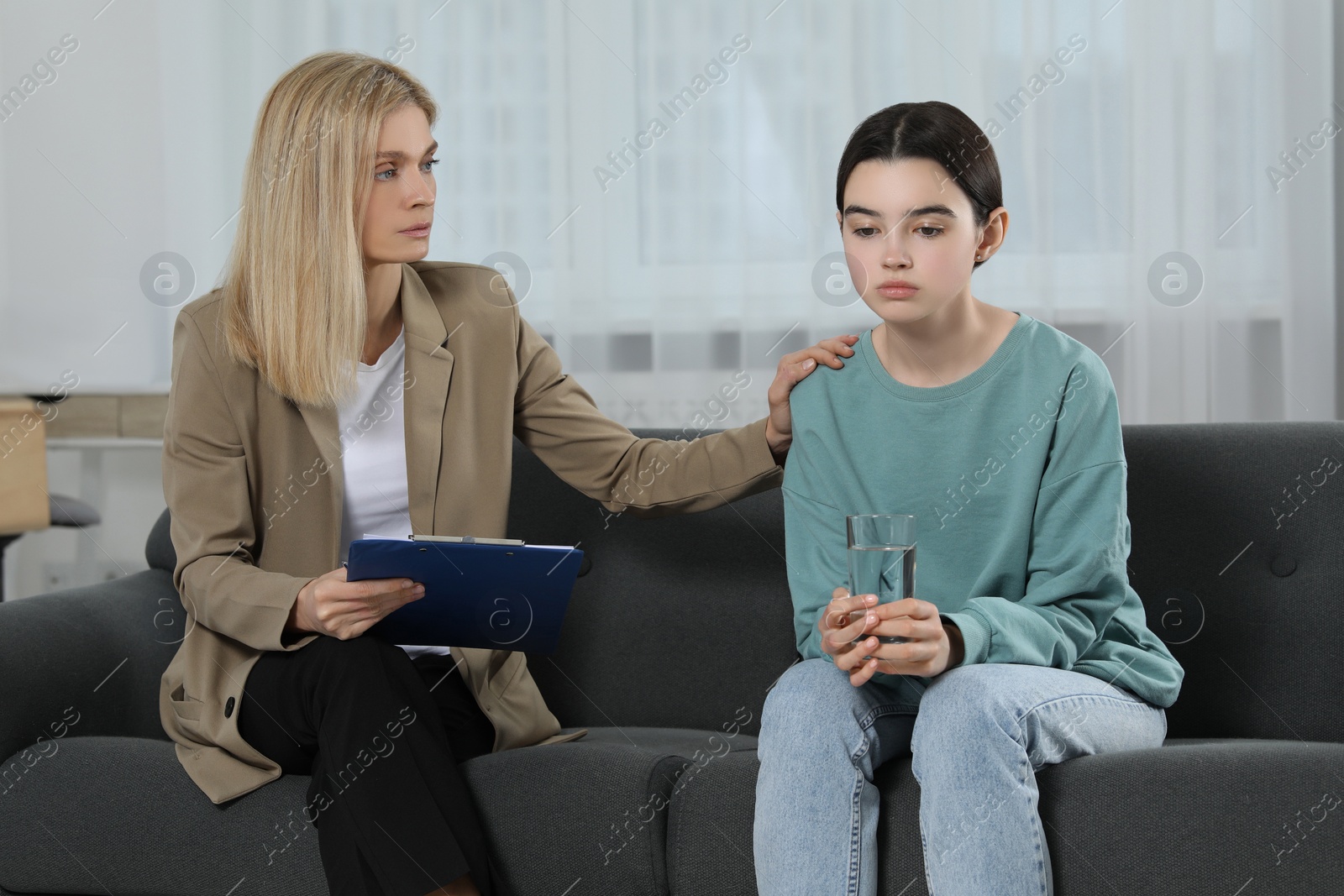 Photo of Psychologist working with teenage girl in office. Teenager problems