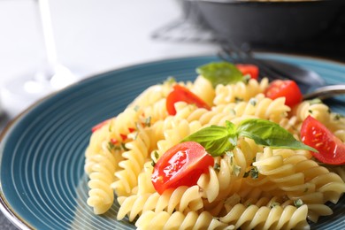 Photo of Delicious pasta with tomatoes and basil, closeup