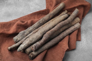 Photo of Raw salsify roots on brown table, closeup