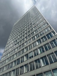 Photo of Beautiful skyscraper outdoors on cloudy day, low angle view