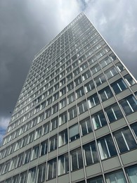 Beautiful skyscraper outdoors on cloudy day, low angle view