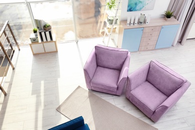 Living room interior with comfortable armchairs, view through CCTV camera