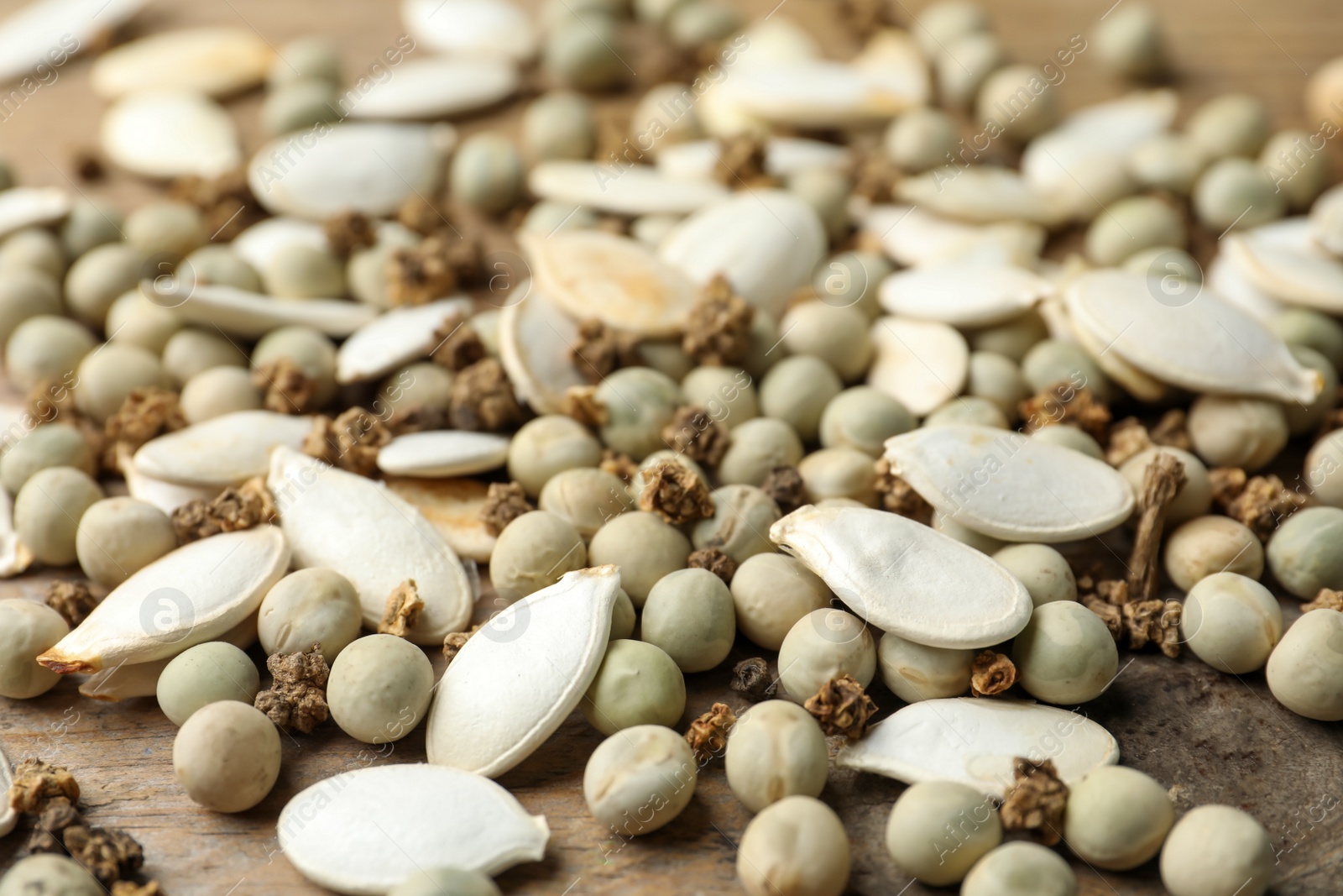 Photo of Mixed vegetable seeds on wooden background, closeup