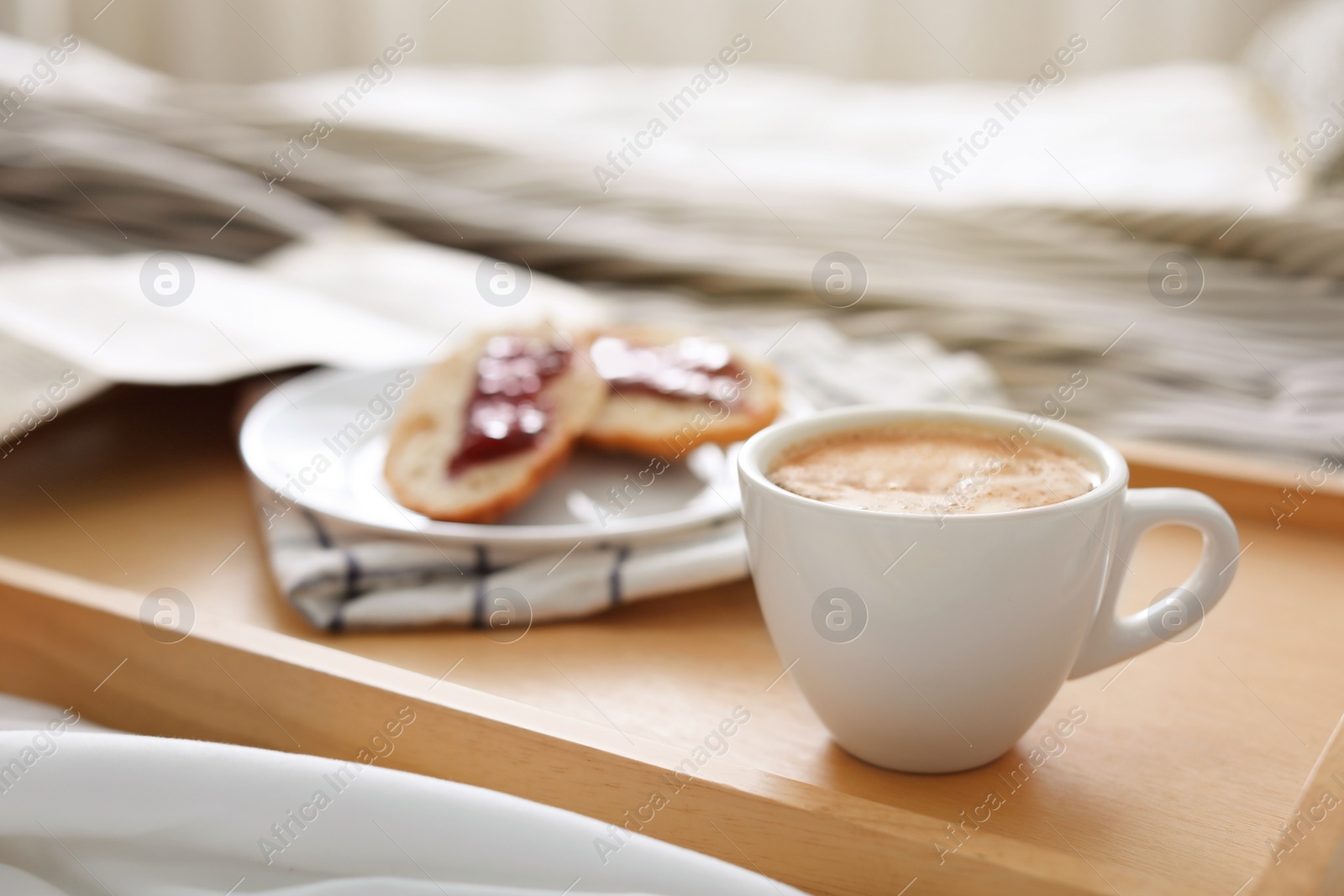 Photo of Morning coffee and sandwiches on tray in bedroom