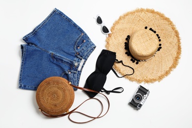 Flat lay composition with stylish bikini on white background. Beach objects