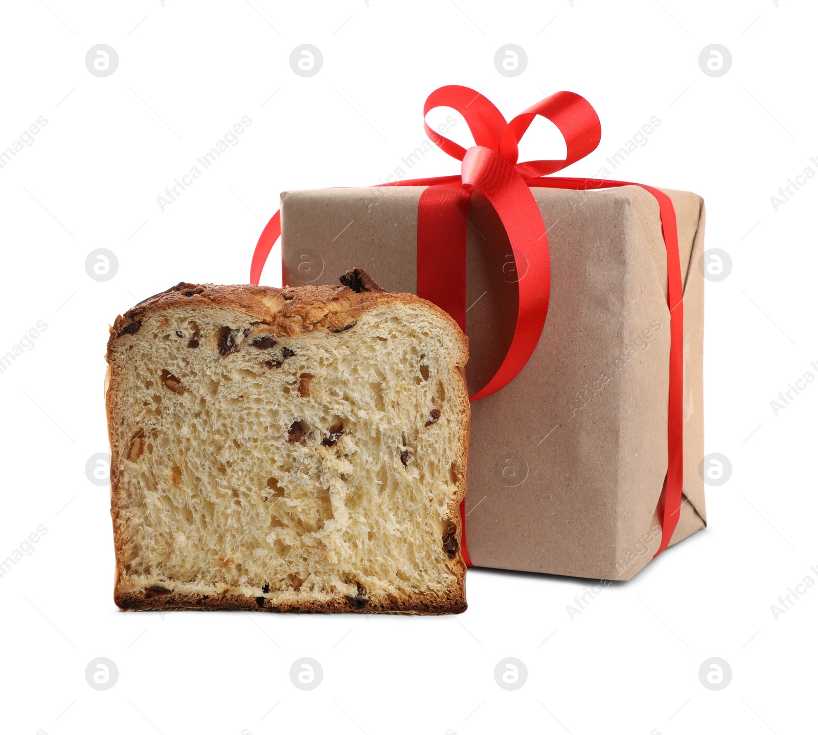 Photo of Half of delicious Panettone cake and gift box on white background. Traditional Italian pastry