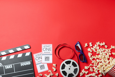 Flat lay composition with cinema tickets on red background, space for text