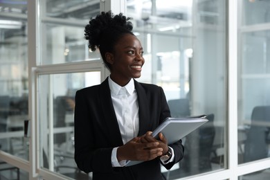 Photo of Happy woman with folders in office. Lawyer, businesswoman, accountant or manager