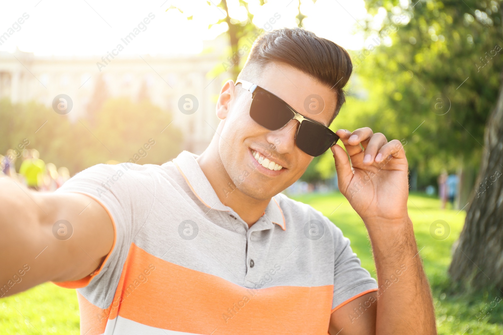 Photo of Handsome man taking selfie in stylish sunglasses