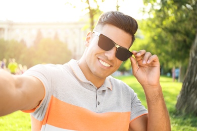 Handsome man taking selfie in stylish sunglasses