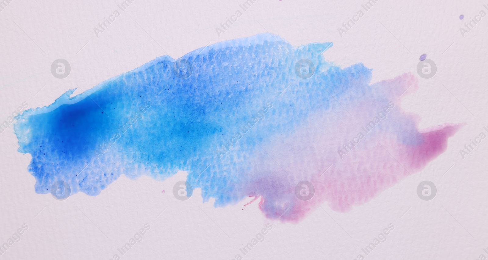 Photo of Blot of bright watercolor paints on white paper, top view